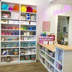 the inside of a children's store with lots of shelves and toys on display