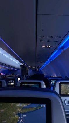 the inside of an airplane with blue lights