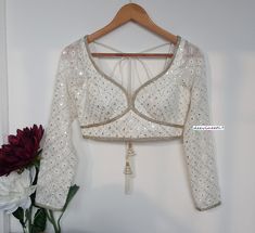 This Made to Order/Made to Measurement/Custom Made Indian Ethnic Blouse. - Fabric - Chikankari Georgette - Color - Off-White - Padded - Princess Cut - Sweetheart Neck - Rich lining  - Long Sleeves - Back Hook Closure - Shoulder String with Latkans PLEASE NOTE: BUYERS ARE RESPONSIBLE FOR ANY CUSTOMS AND IMPORT TAXES THAT MAY APPLY. This is a made to order product. If you opt for 'Made To Measurement Option', we will provide a measurement template and you can share the measurements likewise. If you want to opt for 'Standard Size', Please refer to the size chart provided in the listing. Shipping: Standard Shipping is done by DHL ecommerce and it mostly takes 2 to 3 weeks to deliver after dispatch. Express Shipping is done by DHL express and it mostly delivers within a week after dispatch. Fab Long Sleeve Indian Blouse, Wedding Blouse With Chikankari Embroidery For Transitional Season, Transitional Season Fitted White Choli, Transitional Season White Fitted Choli, White Chikankari Embroidery Blouse For Wedding, Fitted White Blouse Piece With Pallu Detail, Fitted White Blouse Piece With Pallu, Traditional White Fitted Blouse Piece, White Fitted Blouse Piece With Pallu