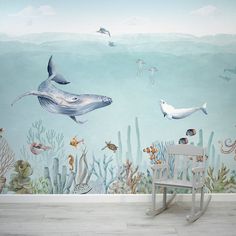 an underwater scene with dolphins and other marine creatures painted on the wall in this children's room