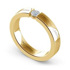 a yellow gold wedding ring with a princess cut diamond in the center, on a white background