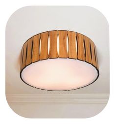 a circular light fixture with wooden strips on the top and bottom, hanging from a ceiling