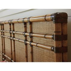 a close up of a bamboo headboard on a bed