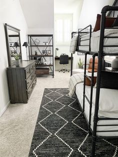 a bedroom with bunk beds, dressers and other items on the carpeted floor