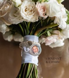 a bouquet of white flowers with a wedding ring on the top and an image of a man's face