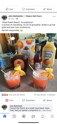 two glasses filled with drinks sitting on top of a table next to bottles of juice