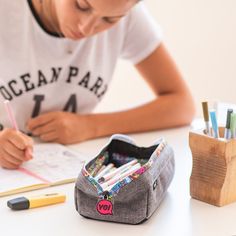 Looking for a versatile pouch that can store both your makeup and pens? Look no further than our Lenny pencil case. With a wide, structured opening and sturdy construction, it's perfect for keeping your pens and pencils organized on the go. Plus, the colorful printed zipper and snazzy lining make it a stylish choice. And when you're not using it to store your writing utensils, it doubles as a cute and functional makeup pouch. The washable polyester construction and lifetime warranty make it a sm Back To School Pencil Case With Zipper, Trendy Pencil Case With Pen Holders For School, Functional Stationery With Pen Holders For Back To School, Functional Stationery For Back To School With Pen Holders, Rectangular Organizers With Pen Slots For Back To School, Trendy Everyday Pencil Case With Pen Slots, Functional Stationery With Pen Holders For Study, Multicolor Pencil Case With Pen Slots For Study, Multicolor Pencil Case With Pen Holders For Study