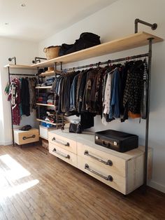 an organized closet with clothes and suitcases