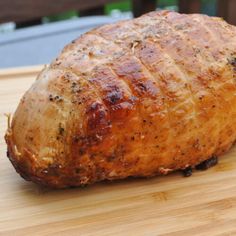 a piece of meat sitting on top of a wooden cutting board