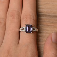 It is a lab alexandrite ring. The main stone is 7 mm*9 mm emerald cut.weight about 2.71 carats. The basic metal is sterling silver and plated with rhodium. To change the metal to a solid gold (white/rose) or platinum is also available, please ask for a quotation if you want. You can also go to my shop Home for more elegant rings: https://www.etsy.com/shop/godjewelry?ref=hdr_shop_menu Alexandrite is June birthstone . More alexandrite rings: https://www.etsy.com/shop/godjewelry?section_id=20715043 Engagement Ring Purple, Wedding Ring Emerald Cut, Alexandrite Rings, Wedding Ring Emerald, Wedding Rings Emerald Cut, White Gold Wedding Ring, Ring Emerald Cut, Pear Cut Engagement Rings, June Birthstone Ring