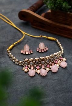 Rose Quartz Kundan and Pearl Choker Necklace Set For Women & Girls Material : Kundan, rose quartz, faux pearl, thread, resin, crystal, glass, and metal Dimension : Necklace - 20 x 3.5 inches approx. Earrings - 1 x 1 inches approx. Rose Quartz, Kundan, and Pearl Choker Necklace Set is a charming piece that will elevate your look to perfection! Dainty stones, in varying sizes and material, are joined together to create this stunning necklace. The finishing touch is given with dangling pearls and r Pink Necklaces For Party And Festivals, Pink Jewelry Sets For Party And Festivals, Festive Pink Necklace For Party, Pink Bridal Necklace For Party Festivals, Adjustable Kundan Necklaces For Party, Adjustable Jewelry Sets For Party And Festivals, Pink Jewelry For Party And Festivals, Festive Pink Party Jewelry, Festive Pink Jewelry Sets For Celebration