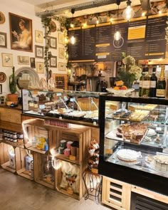 a bakery filled with lots of pies and cakes on display in front of the counter