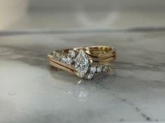 two gold wedding rings with diamonds on them