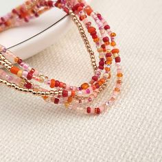 multicolored beaded bracelets on a white surface