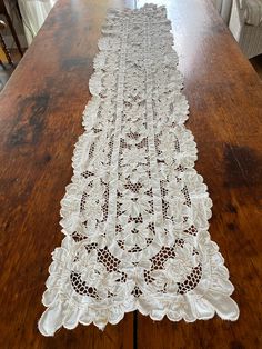 a table runner with white lace on it