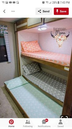 bunk beds in a small room with pink and blue sheets on the bottom bunks