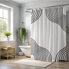 a bathroom with a bathtub, rug and shower curtain in black and white stripes