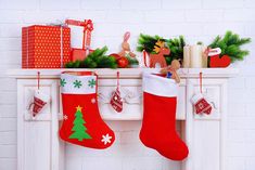 christmas stockings hanging on the fireplace with presents