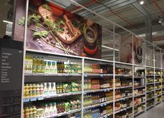 an aisle in a grocery store filled with lots of food and drinks on the shelves