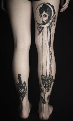 a woman's legs with tattoos on them