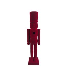 a red toy standing on top of a white surface