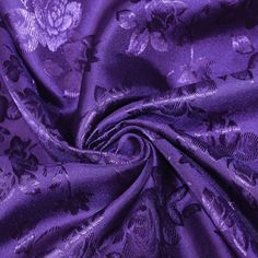 an image of a purple fabric with floral designs on it's edges and sides