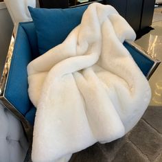 a blue chair with a white blanket on it