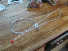 a kitchen counter top with an electric cord attached to it and various items on the counter