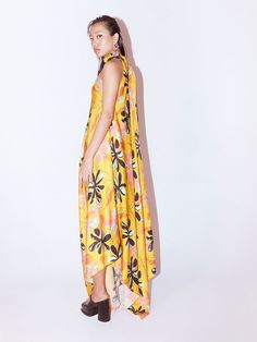 VALUES Handcrafted Organic Fair Minimal Waste Traditional CURATOR'S NOTE The Yellow Dahlia Halter Dress crafted from our stunning vegan silk fabrication has a wide Collar. Made from our unique hand painted and then digitally enhanced Dalia floral print, Featuring halter sleeves, this piece is versatile and easy to wear. It has a centre back opening and an asymmetric hem. It is floor length and has a chic fit. Pair it with heels for an elegant look. Each of our pieces is hand-crafted and made wit Silk Digital Print Party Dresses, Silk Party Dress With Digital Print, Silk Maxi Dress With Abstract Print For Party, Spring Silk Halter Neck Maxi Dress, Spring Printed Silk Dress, Yellow Satin Midi Dress For Spring, Sleeveless Silk Floral Print Summer Dress, Spring Silk Maxi Dress With Abstract Print, Yellow Floral Print Silk Dress