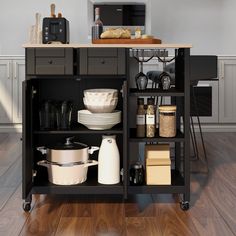 a kitchen island with pots, pans and other cooking utensils on it