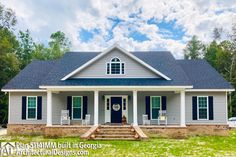 a white house with black shutters on the front porch and steps leading up to it