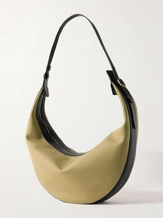 KHAITE Augustina leather-trimmed canvas shoulder bag | NET-A-PORTER Luxury Coated Canvas Hobo Bag With Leather Handles, Luxury Hobo Bag With Leather Handles And Coated Canvas, Luxury Canvas Bags With Leather Lining, Modern Canvas Evening Bag, Modern Evening Canvas Bag, Modern Evening Canvas Bags, Classic Canvas Evening Bag, Luxury Canvas Evening Bags, Luxury Evening Canvas Bags