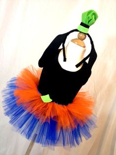 an orange and blue tutu skirt with a bottle in the shape of a witch