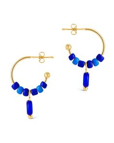 Add a touch of coastal charm to your wardrobe with these Sibyl Evil Eye Beaded Hoop Earrings. Featuring the ancient symbol of protection, these blue beaded hoops will add a hint of beachy elegance to any outfit. Embrace the luxurious and exclusive look of these earrings, perfect for any occasion. Material: 14K gold or rhodium plated brass, colored glass beads Features: 0.75" hoop, 0.6" charm, 3.75mm beads, 7.65mm evil eye bead, Lead & Nickel free, post back Symbol Of Protection, Solid Gold Bracelet, Coastal Charm, Solid Gold Earrings, Statement Drop Earrings, Mens Accessories Jewelry, Beaded Hoop Earrings, Men Earrings, Beaded Hoops