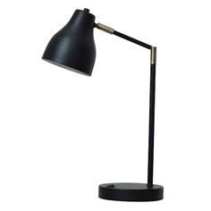 a black and gold desk lamp on a white background with clippings to the side