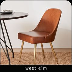 a brown leather chair sitting next to a table with a plate on top of it