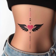 a woman's stomach with an arrow and heart tattoo on the side of her belly