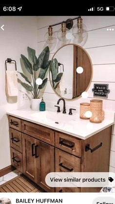 a bathroom vanity with two mirrors and a plant on it's side, in front of a white shiping wall