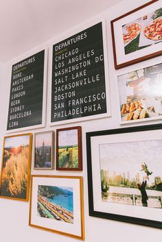 a wall with many framed pictures on it