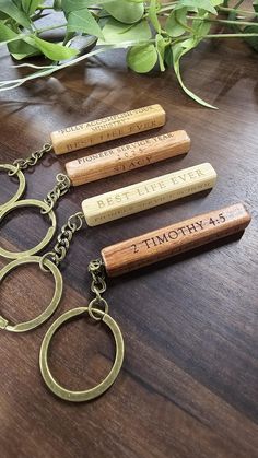 four personalized wine cork keychains on a table