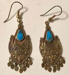 These lovely pair of dangling turquoise earrings are an estate find in Atlanta and appear to be made of brass or bronze with inlay turquoise. Estimated to date to the 1980s (90s at the latest), the earrings have the look of Balinese jewelry based on the metal work and styling. The little French hooks appear to be replacements and are unmarked. These would be easily swapped out by the next buyer if desired. In good vintage preowned condition, these are free of damage or repair. I'm selling this p Turquoise Bohemian Brass Jewelry, Bohemian Turquoise Brass Jewelry, Blue Pierced Copper Earrings, Blue Copper Pierced Earrings, Traditional Blue Brass Earrings, Festival Turquoise Metal Earrings, Antique Finish Copper Dangle Earrings, Antique Jewelry For Pierced Ears, Bronze Antique Finish Dangle Earrings