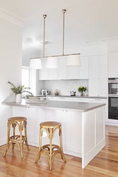 two stools are in front of the kitchen island