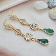 "Art Deco earrings long, boho wedding earrings, emerald green statement earrings, vintage style earrings These long art deco earrings exudes elegance and sophistication.  With a fan shaped posts followed by peach glass crystals and emerald green teardrop stones, you will be immediately transported to a glamorous 1920s soiree. Due to hygienic reasons, I do not accept returns/exchanges on earrings Materials : glass crystals with gold plated setting, gold vermeil ear posts DIMENSION: -------------- Green Art Deco Drop Earrings, Art Deco Green Jewelry For Pierced Ears, Green Chandelier Earrings For Anniversary, Green Dangle Chandelier Earrings For Anniversary, Gold Emerald Drop Earrings For Bridal, Gold Emerald Earrings For Wedding, Green Dangle Earrings For Anniversary, Green Dangle Bridal Earrings For Anniversary, Elegant Gold Bridal Earrings With Emeralds