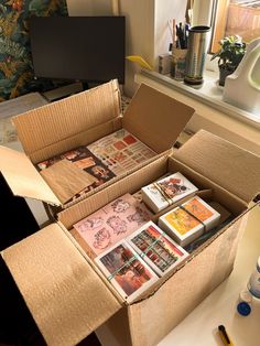 an open cardboard box filled with lots of cards