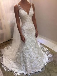 a woman in a wedding dress posing for the camera