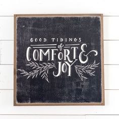 a black and white sign that says, good tidings of comfort & joy