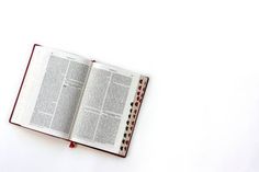 an open book sitting on top of a white table