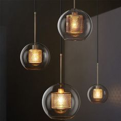 three glass globe lights hanging from a ceiling