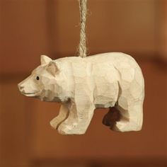 a white bear ornament hanging from a rope