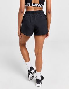 a woman wearing black shorts and a crop top with the word run printed on it